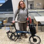 Amelia Katanski with a folding bicycle